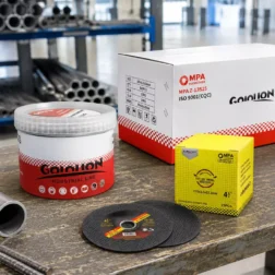 105mm ultra-thin cutting discs and wholesale carton placed on a metal fabrication bench with steel rebar, showing the extra cutting depth capacity for industrial processing